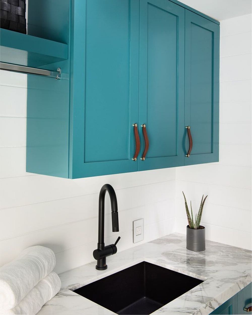 A little black on black action with this laundry room sink and faucet