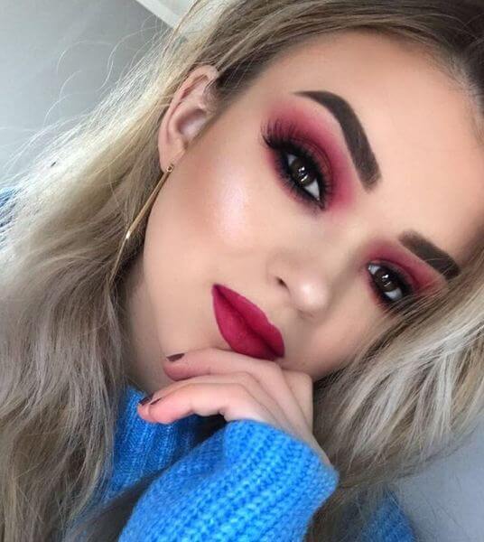 Dark eye makeup and lipstick together.