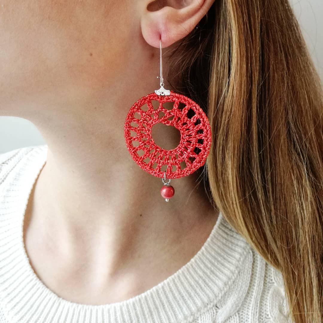Red crocheted, drop earrings made with a metal hoop and yarn.