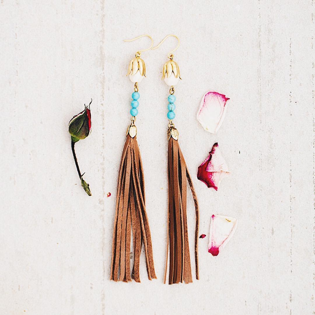 When you need a long statement pair of earrings that will turn heads reach for our Turquoise and natural leather tassel earrings with a tough of cream beads.
