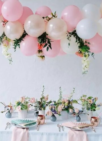#Wedding #Decoration #Balloons Banquet area hanging decoration consisting of pink and cream balloons, flowers and green plants