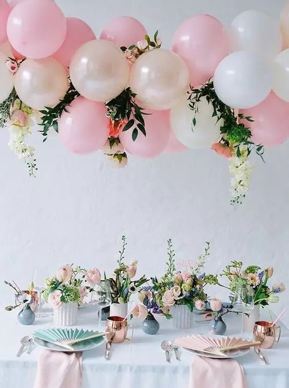 #Wedding #Decoration #Balloons Banquet area hanging decoration consisting of pink and cream balloons, flowers and green plants