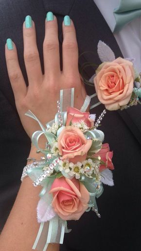 Beautiful corsage and matching coral and mint boutonniere