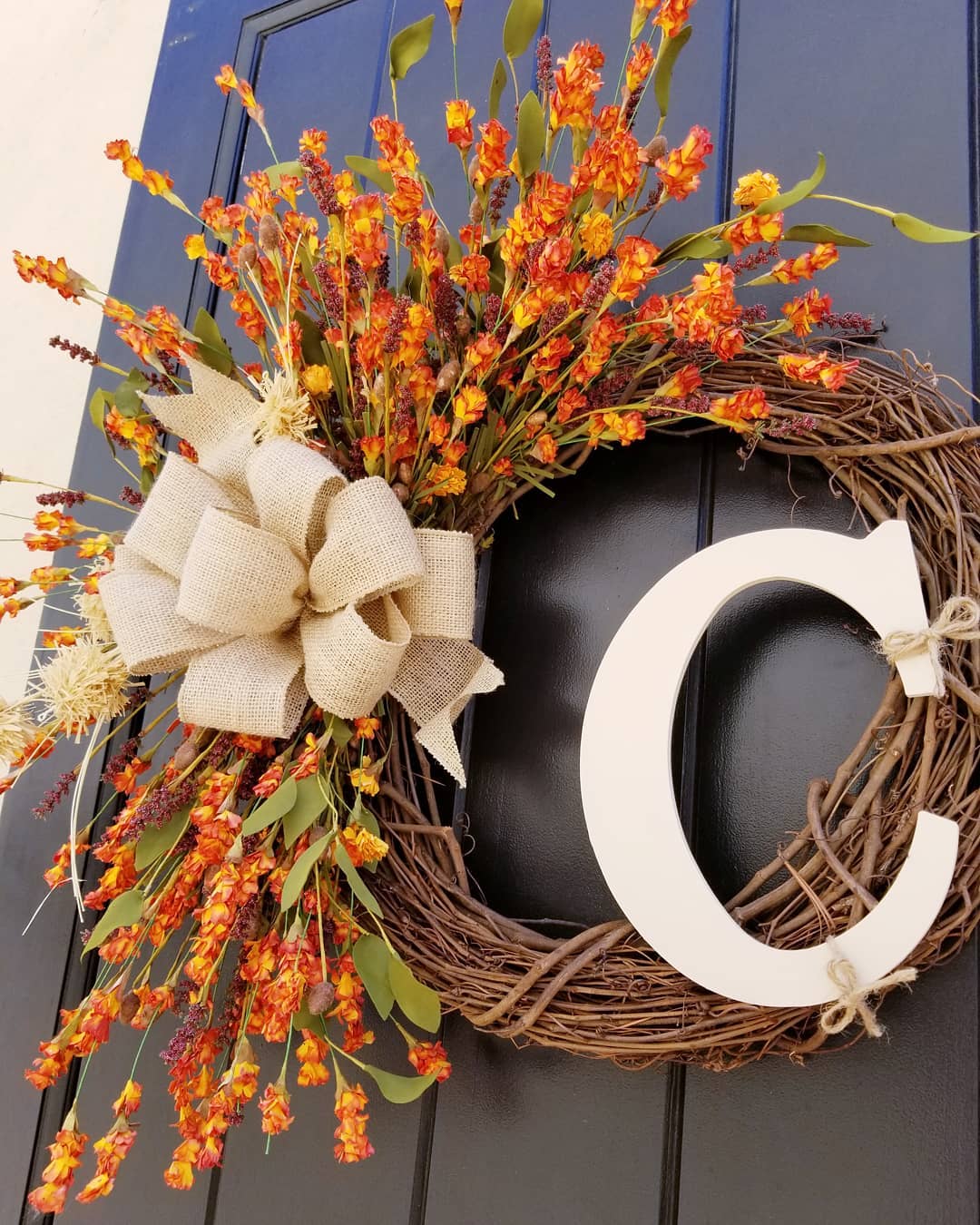 Thanksgiving front door wild orange flowers wreath.