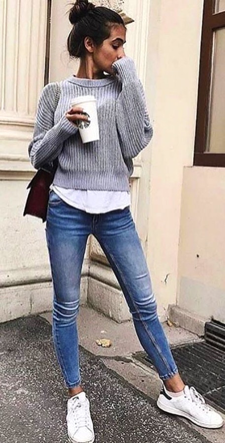 Women's corduroy sweatshirt, blue jeans and pair of white low-top sneakers outfit.
