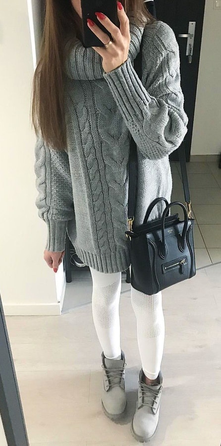 Women's gray cowl-neck sweater and white leggings.