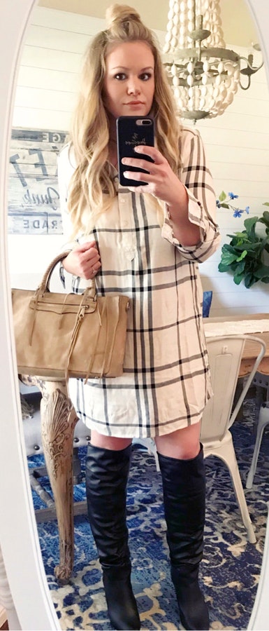 Women's white and gray plaid long-sleeved shirt dress, pair of black knee high boots and brown handbag.