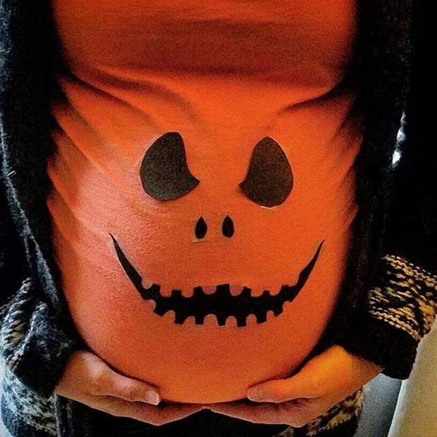 Create the pumpkin face out of paper, fabric or felt.