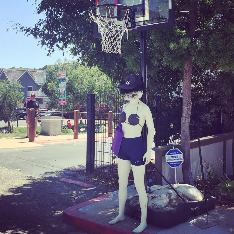 Freaky skull faced mannequin mascot in a bikini.