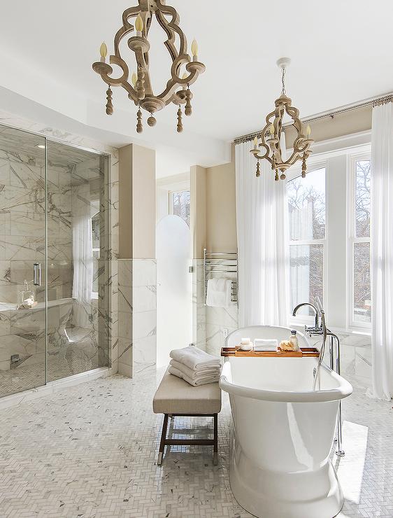 Glam Master Bathroom with Freestanding Diagonal Bathtub.