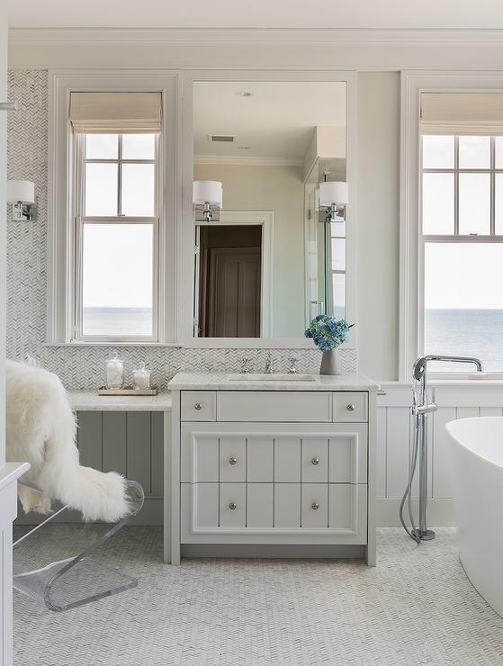 Master Bath with Marble Herringbone Backsplash and Floors.