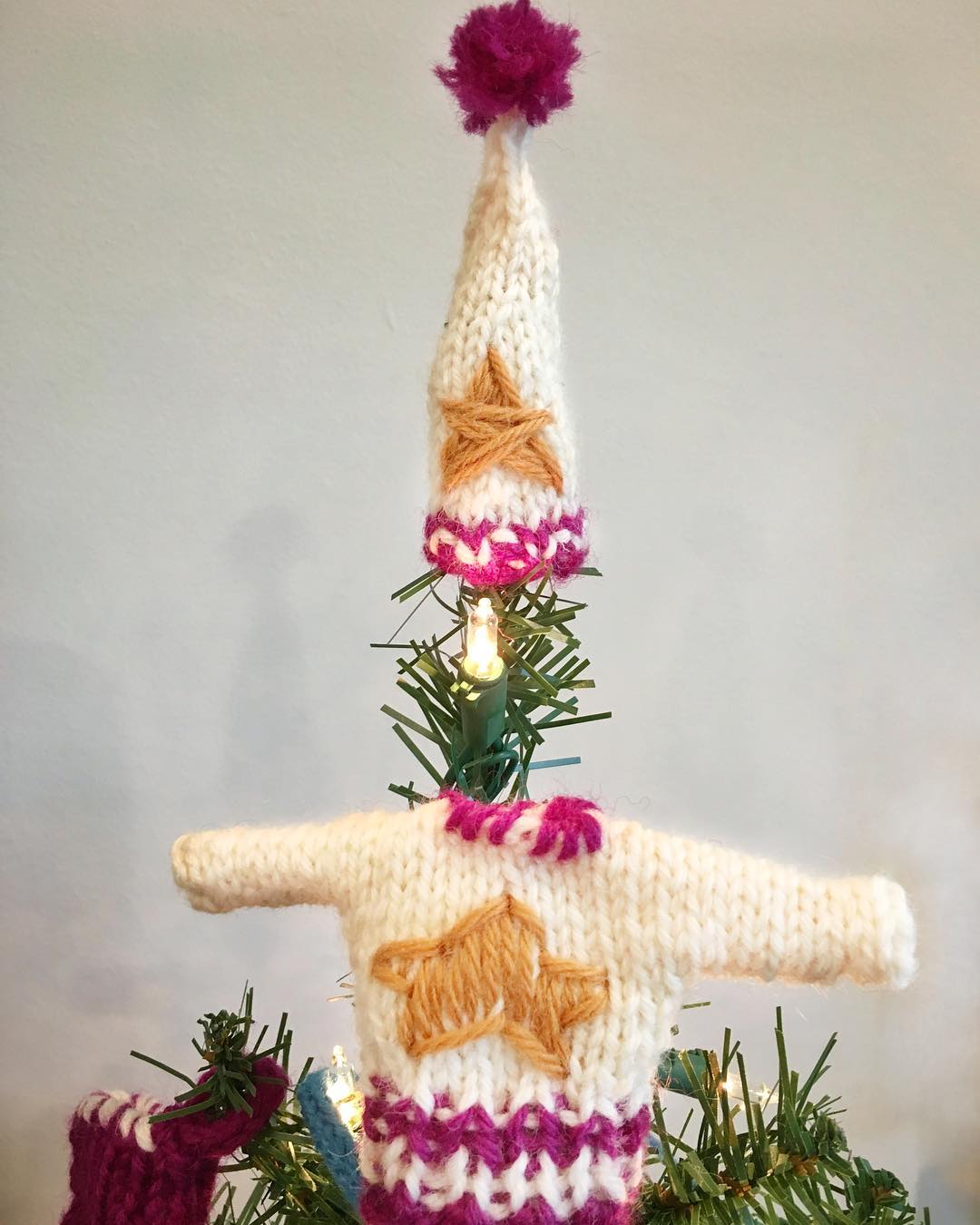 Mini handknit stocking cap & sweater set as tree topper.