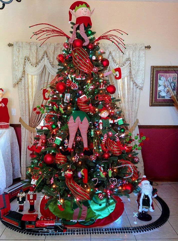 Noga Evelyn adorned her Alberta Spruce Evergreen Tree with elves, candycanes and ornaments in red and green.