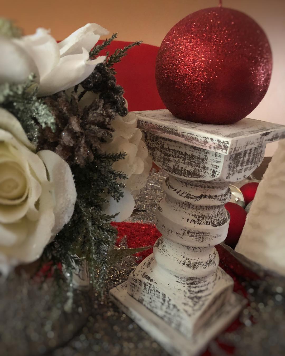 Red glitter candle in dinning room table with the white chippy candleholder!