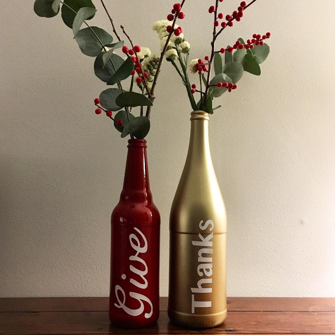 The bottles are spray painted and the letters have cut off white labels.