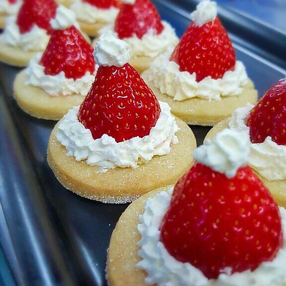 These gorgeous shortbread Christmas Santa hat desserts are the handiwork.  Christmas Ornaments For Foodies