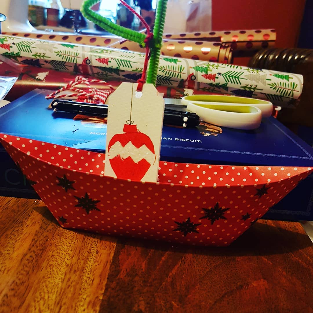 Unusual present wrapping technique an origami boat. DIY Christmas Ornaments