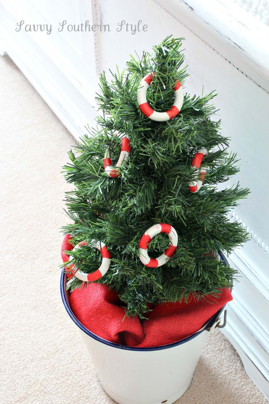 A small tree in a Christmas decorated bedroom gets some nautical flair.
