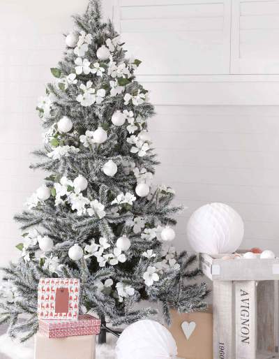 A white Christmas tree covered with white flower ornaments.