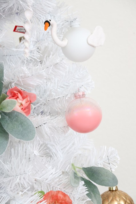 All the colorful ornaments will display properly on the white tree.