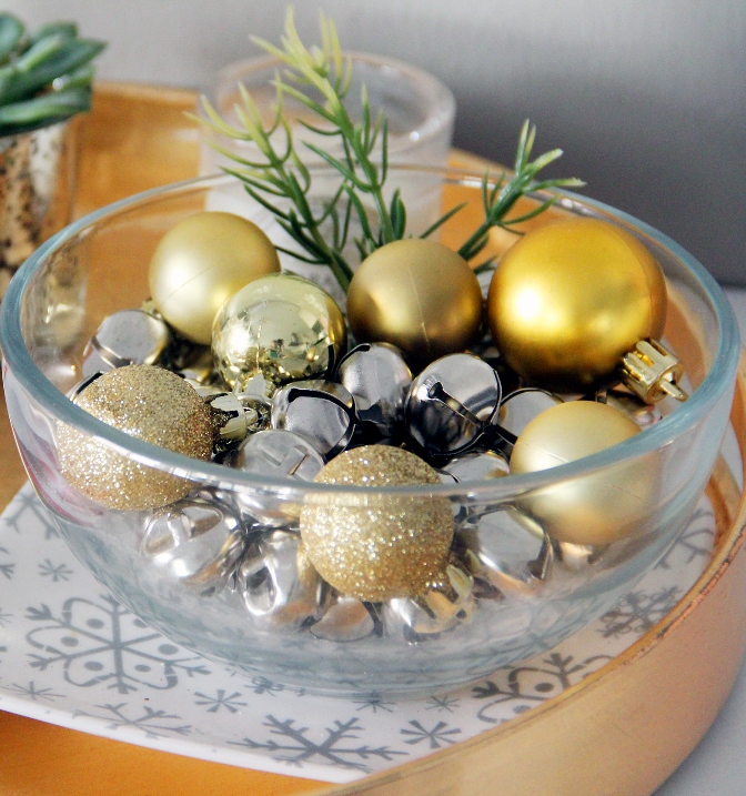 Bells and shiny baubles in a large glass bowl.