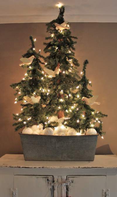 Rustic design idea incorporates multiple smaller Christmas trees.