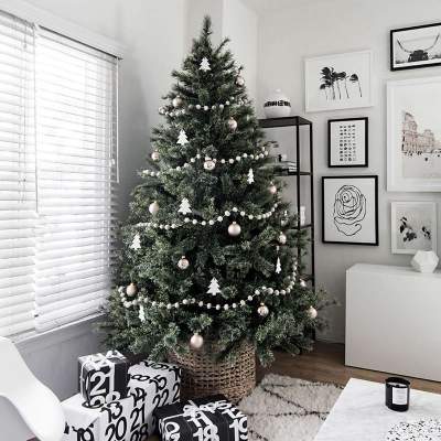 Scandinavian-inspired Christmas tree of silver and black ornaments.