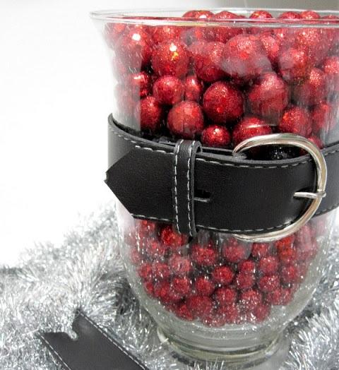 This decorative vase is cute to perfection with its black belt and its bouquet of bright red balls.