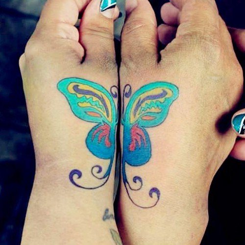 Colorful Matching butterfly tattoo on hand