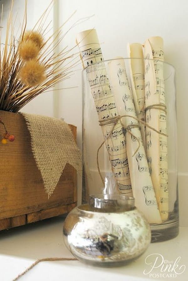 Music sheets displayed in a delicate glass jar.