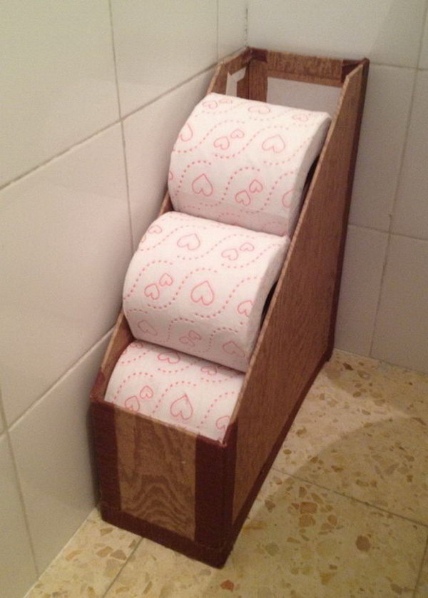 Repurpose a magazine rack to hold toilet paper rolls.