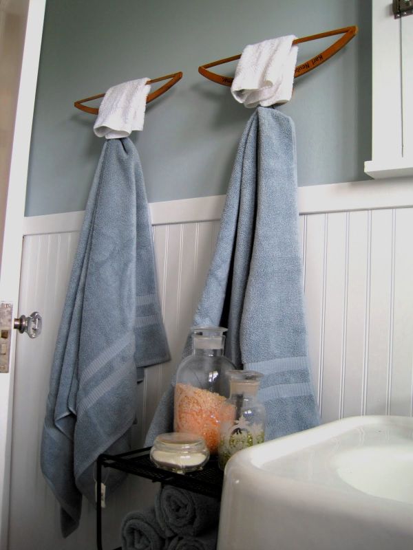 Repurpose wooden clothing hanger into a towel rack. organize your home