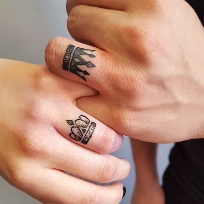 Crowns on the ring finger tattoos.