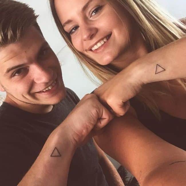 Matching geometric tattoos for couples.