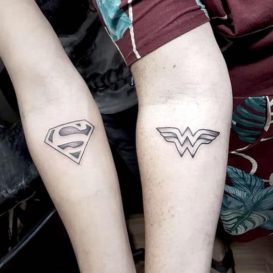 The Superman and Wonder Woman tattoos.