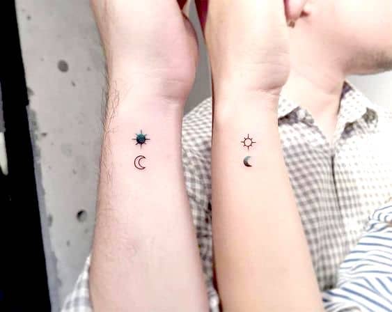 The moon and sun matching wrist tattoos.