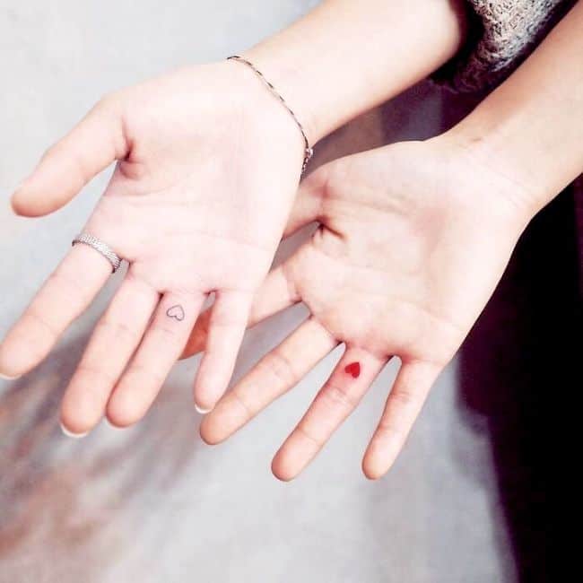 Tiny finger tattoos for couples.
