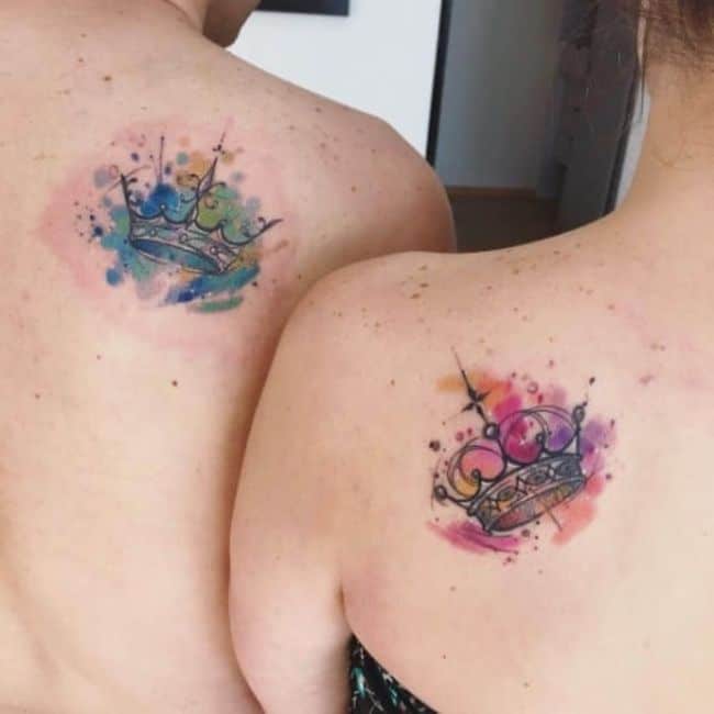Watercolor king and queen tattoos on the back.
